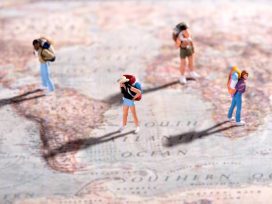 Tourist figurines on a map of Europe